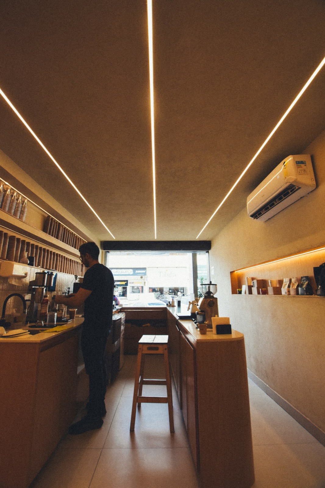 Staff member behind the counter of a coffee bar